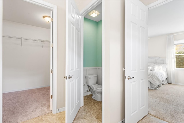 bathroom with toilet and tile patterned flooring