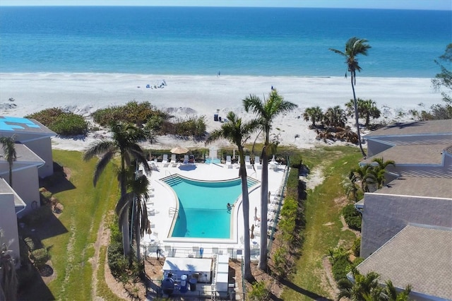 drone / aerial view with a water view and a beach view