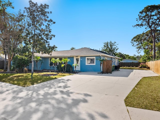 ranch-style home with a front lawn