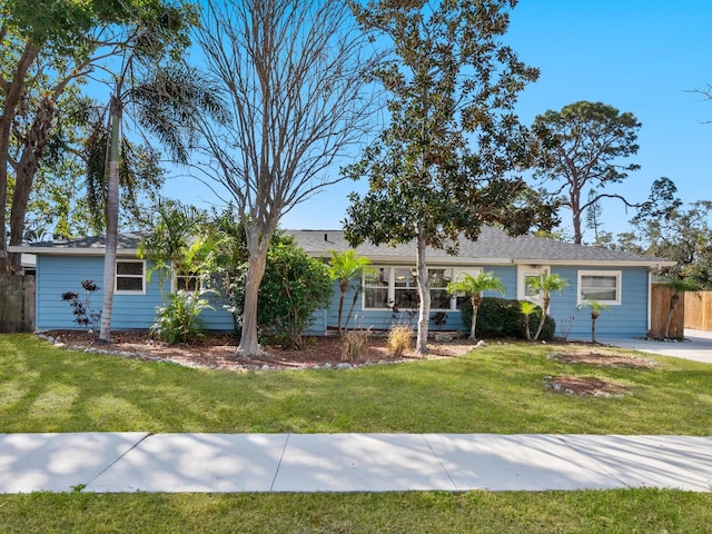 single story home featuring a front lawn