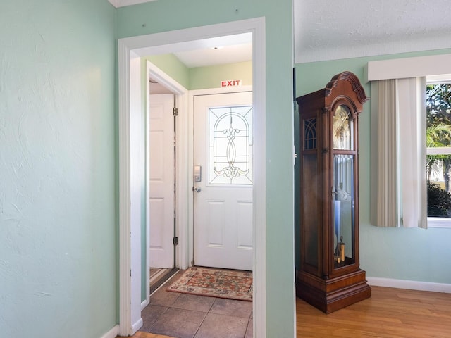 entrance foyer with hardwood / wood-style floors and a textured ceiling