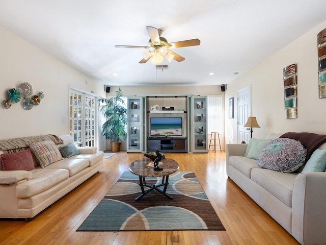 living room featuring ceiling fan and light hardwood / wood-style flooring