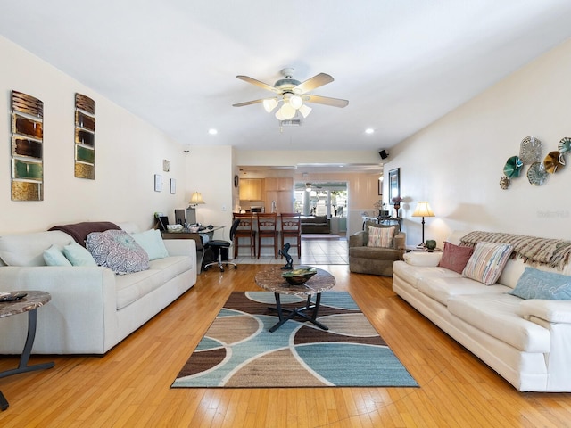 living room with hardwood / wood-style flooring and ceiling fan