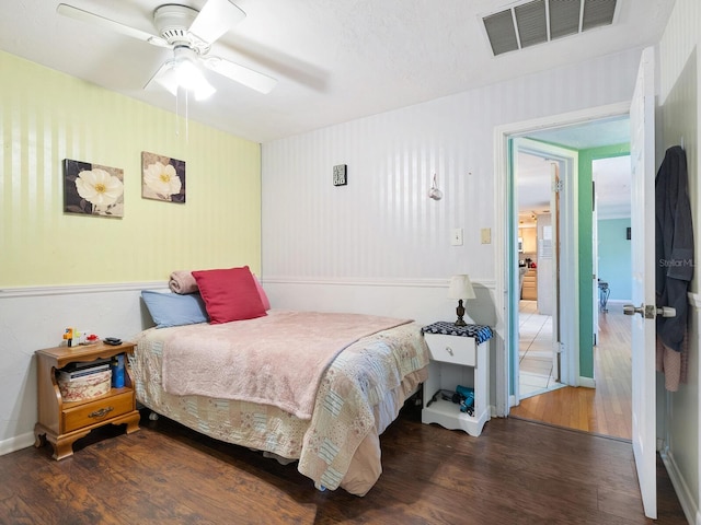 bedroom with ceiling fan and dark hardwood / wood-style flooring