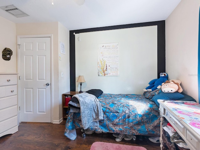 bedroom with dark wood-type flooring