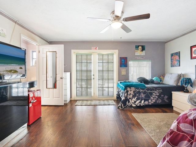 bedroom featuring ornamental molding, dark wood-type flooring, ceiling fan, and french doors