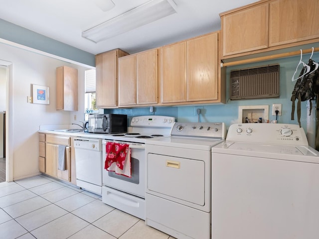 kitchen with light tile patterned flooring, white appliances, separate washer and dryer, and light brown cabinetry