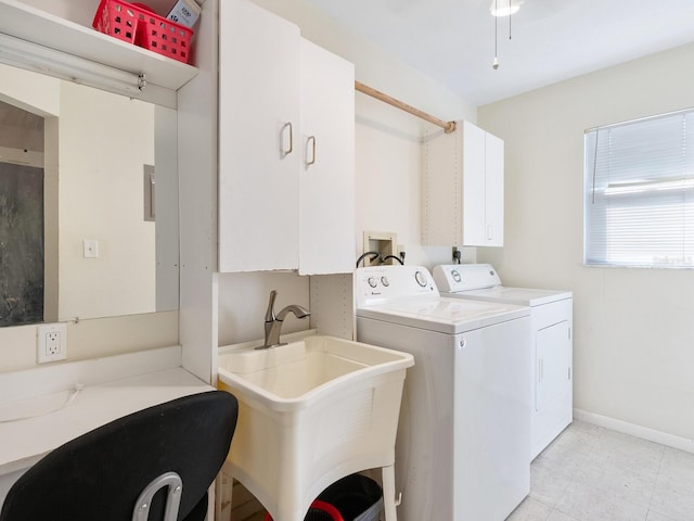 washroom featuring sink, washer and clothes dryer, and cabinets