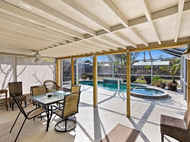 view of patio featuring ceiling fan, glass enclosure, and a pool with hot tub