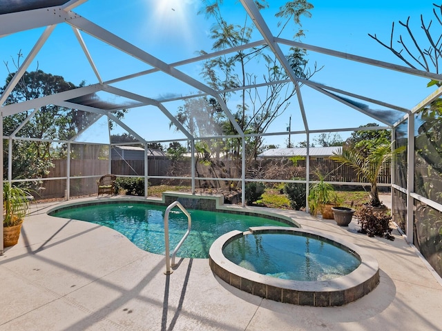 view of swimming pool with an in ground hot tub, a patio area, and glass enclosure