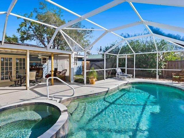 view of swimming pool featuring an in ground hot tub, a patio, and glass enclosure