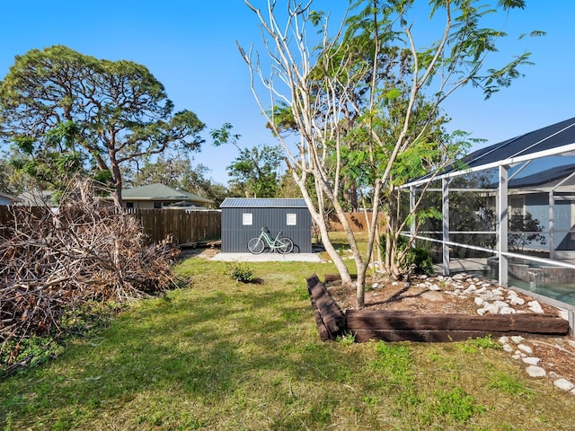 view of yard featuring a lanai and a shed