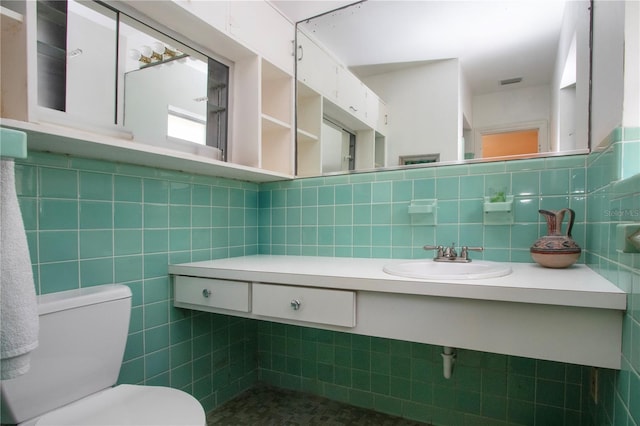 1555 Flower Dr, Sarasota, FL 34239 - bathroom featuring sink, tile walls, and toilet