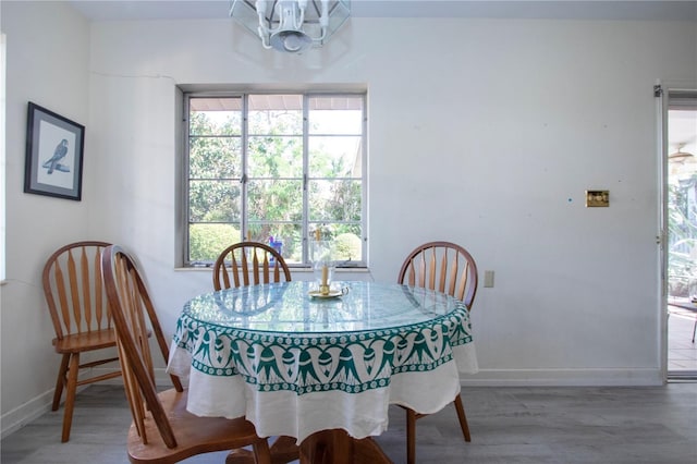 1555 Flower Dr, Sarasota, FL 34239 - dining space with hardwood / wood-style floors and a notable chandelier