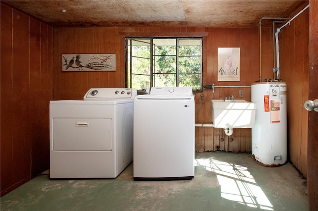 1555 Flower Dr, Sarasota, FL 34239 - clothes washing area with water heater, washer and clothes dryer, wood walls, and sink