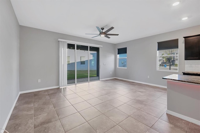 unfurnished living room with light tile patterned floors and ceiling fan