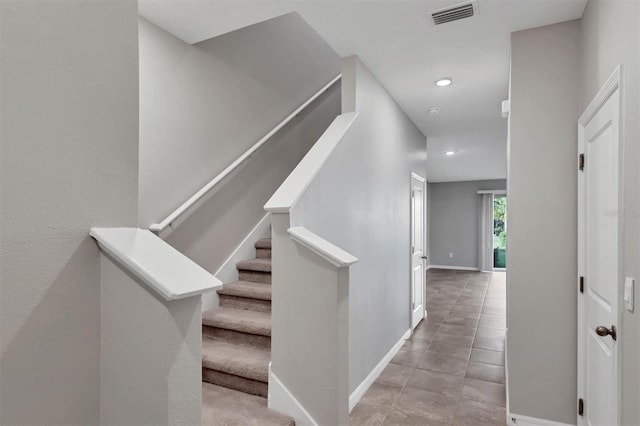 staircase featuring tile patterned floors