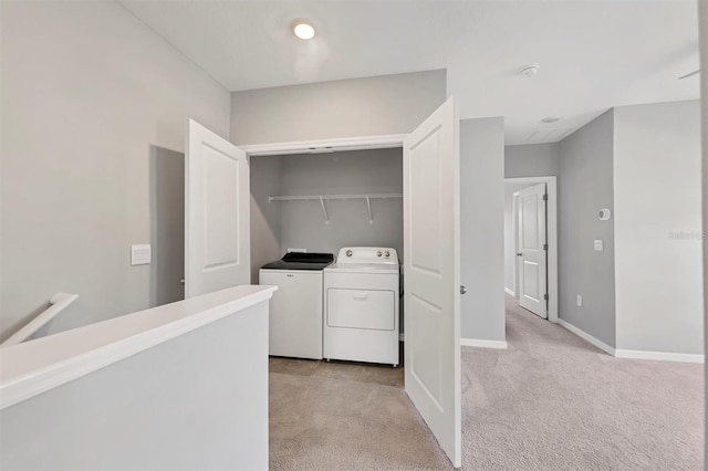 washroom with separate washer and dryer and light carpet