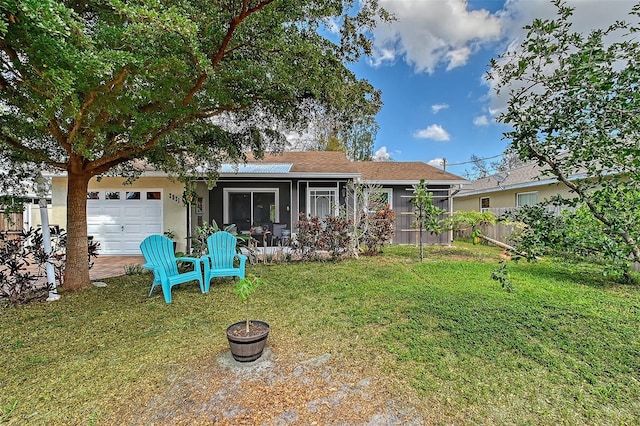 view of front of property with a garage and a front yard