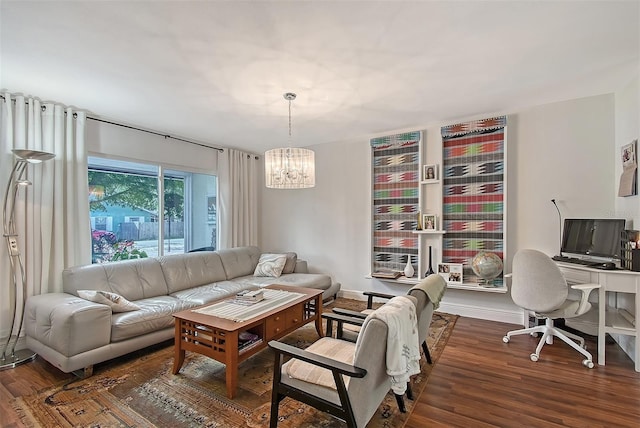 living room with an inviting chandelier and dark hardwood / wood-style flooring