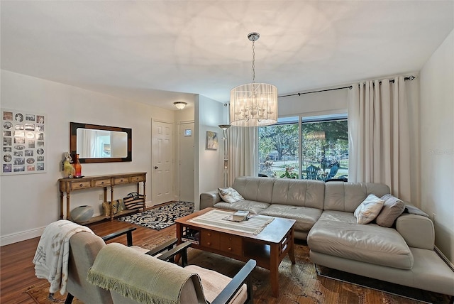 living room with dark hardwood / wood-style floors and a chandelier