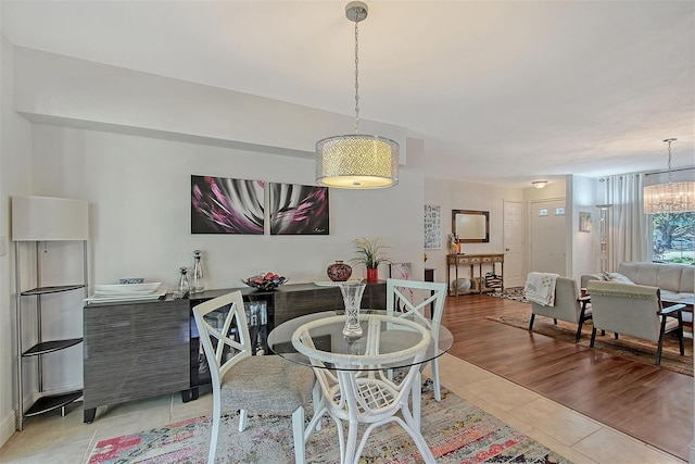 tiled dining area featuring a notable chandelier