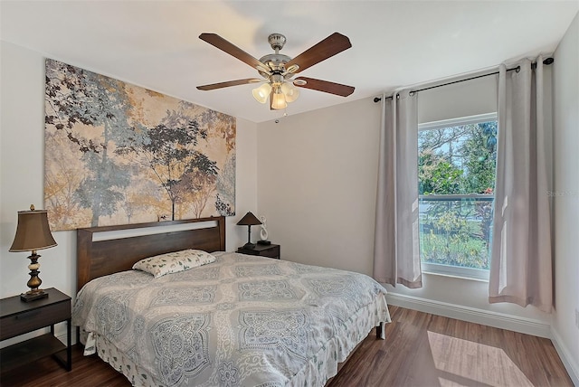 bedroom featuring ceiling fan and dark hardwood / wood-style flooring