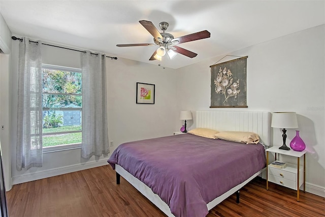 bedroom with ceiling fan and dark hardwood / wood-style floors