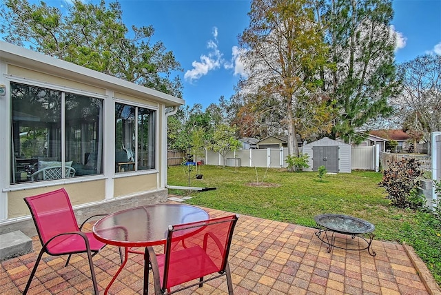 view of patio / terrace with a storage shed and an outdoor fire pit