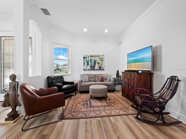 living room featuring ornamental molding and hardwood / wood-style floors