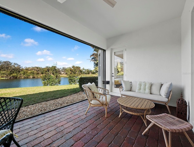 sunroom / solarium featuring a water view