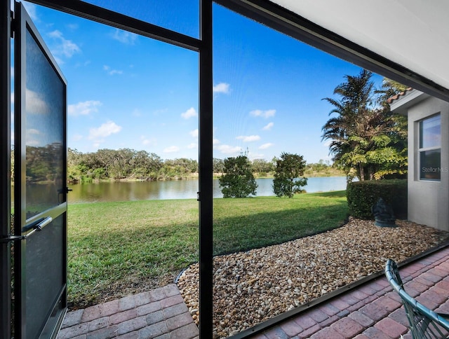 sunroom / solarium featuring a water view