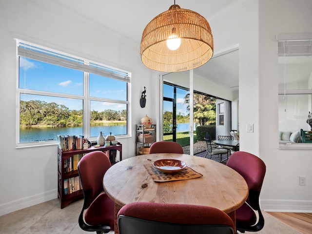 dining room featuring a water view