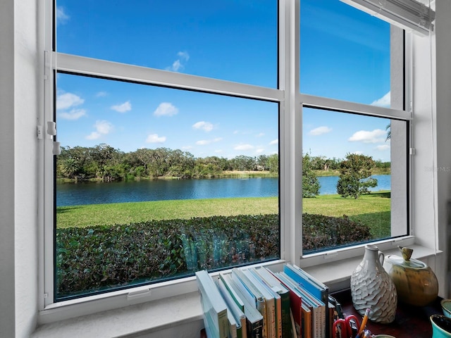 sunroom / solarium featuring a water view