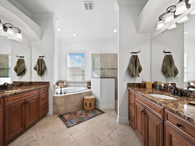 bathroom with crown molding, tile patterned floors, shower with separate bathtub, and vanity