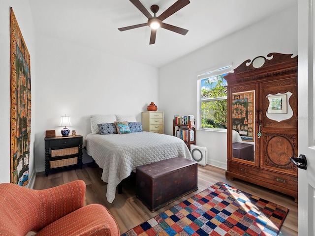 bedroom with hardwood / wood-style flooring and ceiling fan