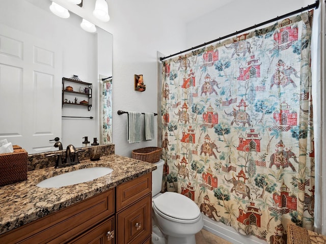 bathroom with vanity, curtained shower, and toilet