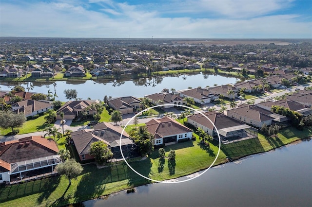 birds eye view of property with a water view