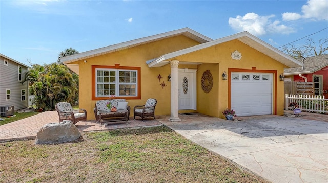 view of front of property with a garage, concrete driveway, fence, and stucco siding