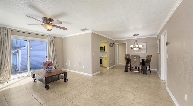 living area with a textured ceiling, ornamental molding, and visible vents