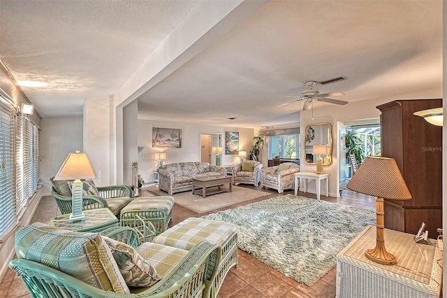 living room with ceiling fan and light tile patterned floors