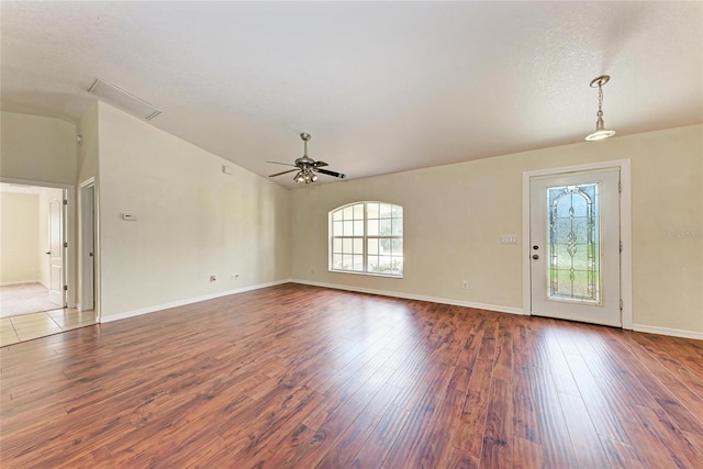 interior space featuring lofted ceiling, a textured ceiling, dark wood-type flooring, and ceiling fan