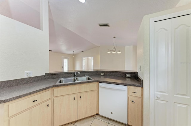 kitchen featuring lofted ceiling, sink, light tile patterned floors, white dishwasher, and kitchen peninsula