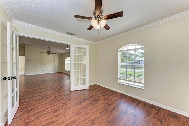 unfurnished room featuring crown molding, ceiling fan, dark hardwood / wood-style floors, a textured ceiling, and french doors