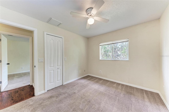 unfurnished bedroom featuring ceiling fan, carpet flooring, and a closet