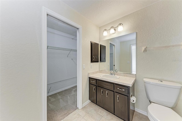 bathroom with vanity, tile patterned flooring, and toilet