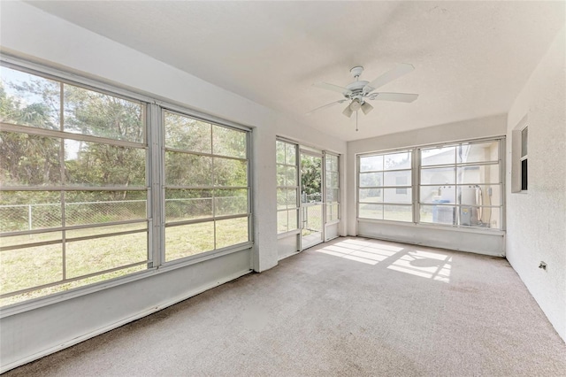 unfurnished sunroom featuring ceiling fan