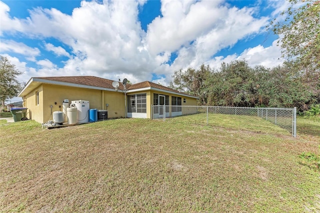 back of property with a yard, central AC, and a sunroom