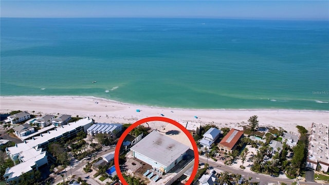 birds eye view of property with a view of the beach and a water view