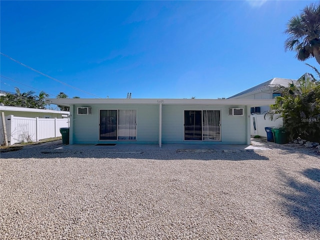 rear view of house featuring fence